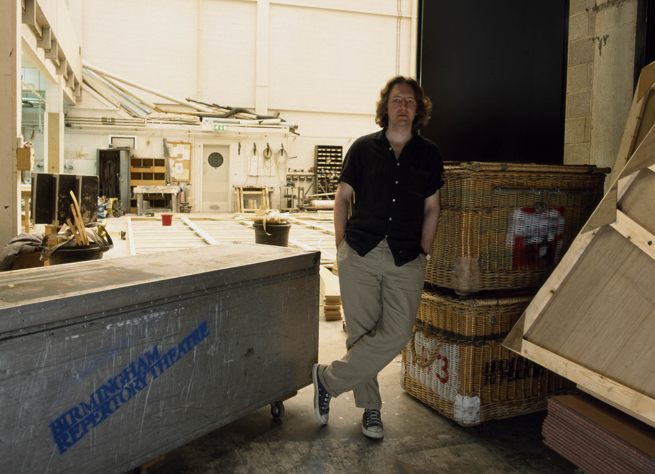 Backstage - man leaning against wicker crate