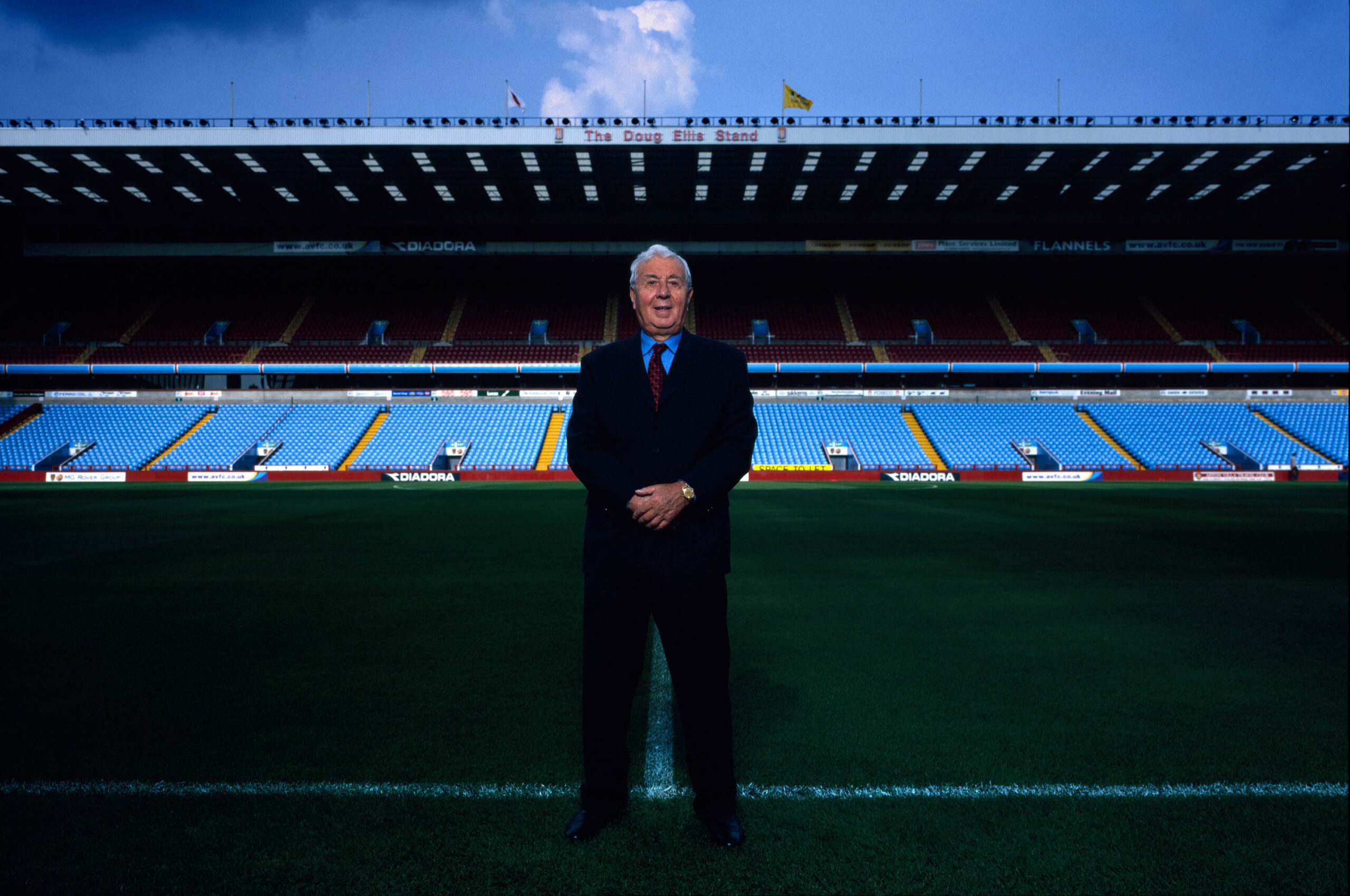 Man in front of football statium