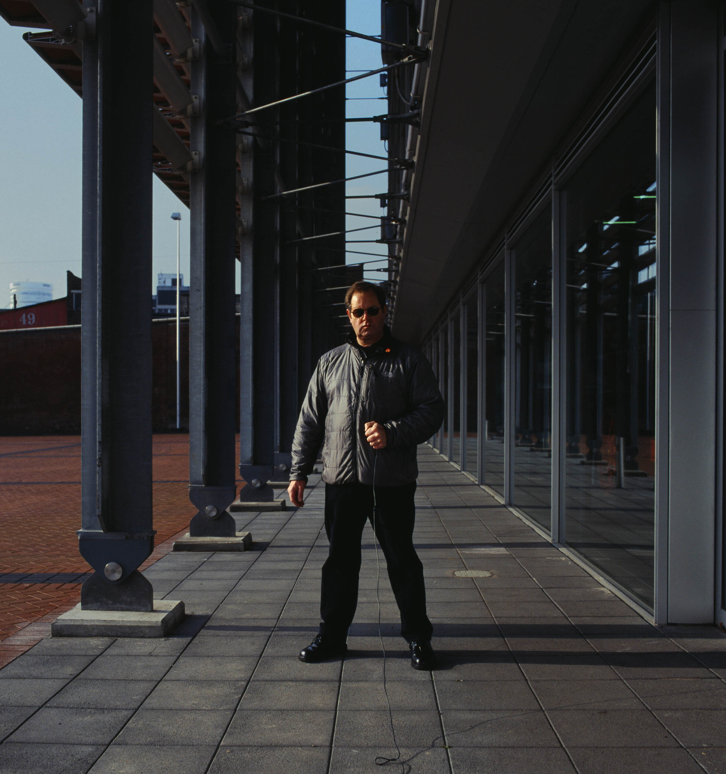 lorentz gullachsen in strong pose outside building in Birmingham, grey top and sunglasses